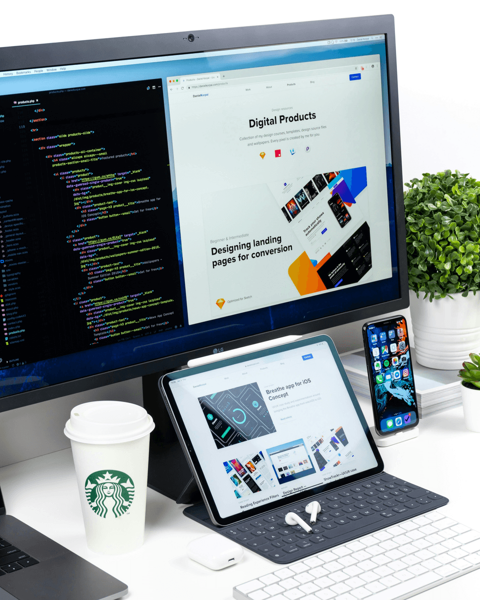 A picture of electronic devices standing on a desk with design apps opened